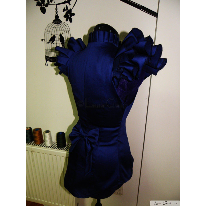 Back view of the blue Celia jacket with a bow at the waist