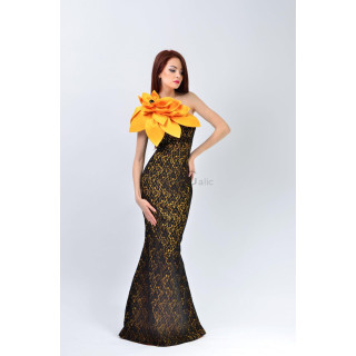 Izaura 3 long dress with a black-and-gold ornamental print and yellow-orange shoulder flower