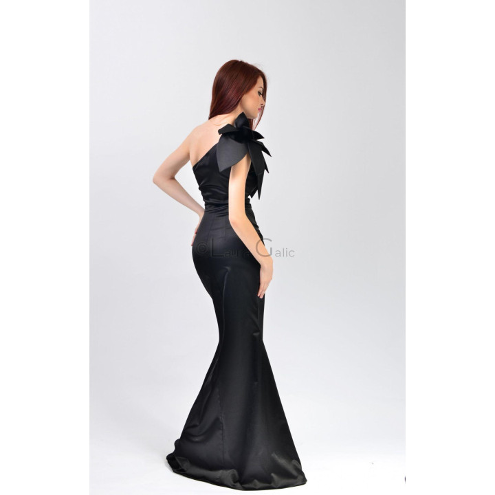 Back view of the fitted black Izaura 3 gown, flaring towards the hem