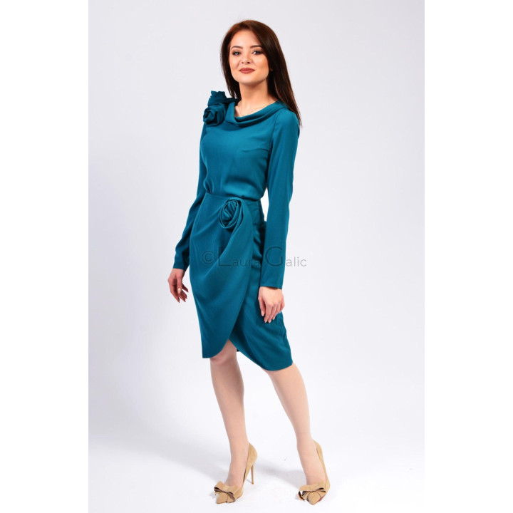 Teal Donatela dress with a wrap-effect skirt and asymmetric hem, styled with beige shoes