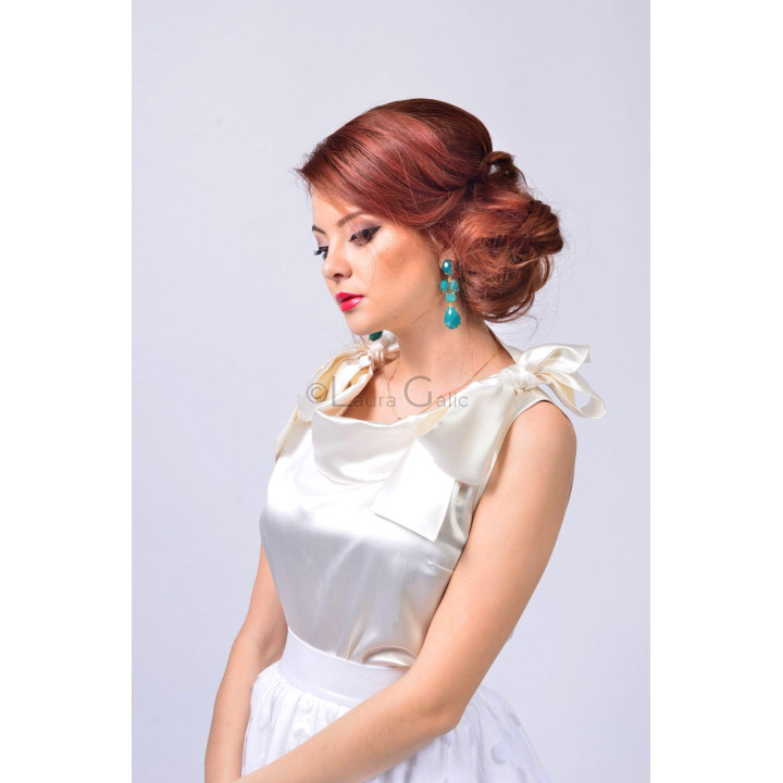 Close-up of the ivory Letitia 3 blouse with a draped neckline and oversized shoulder bow