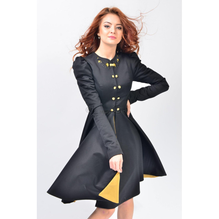 Black Lorelei coat with a full skirt, yellow lining and gold buttons