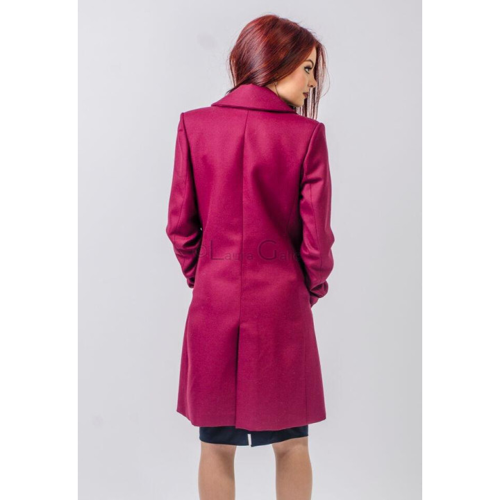 Back view of the Lucille coat showing its central seam and knee-length cut