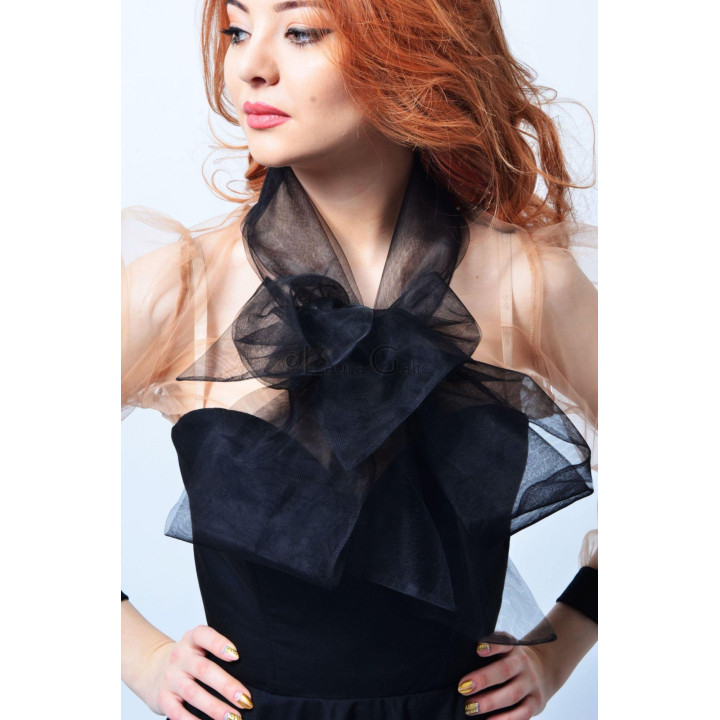 Detail of the Odille dress's large bow and sheer sleeves