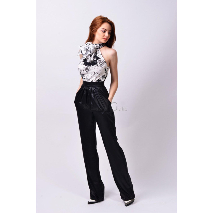 Paula blouse in a black-and-white floral print with a neck bow, styled with black trousers