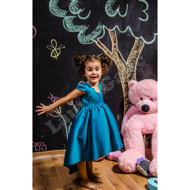 Turquoise Mini Alegra Dress with a full skirt and short sleeves, worn by a child
