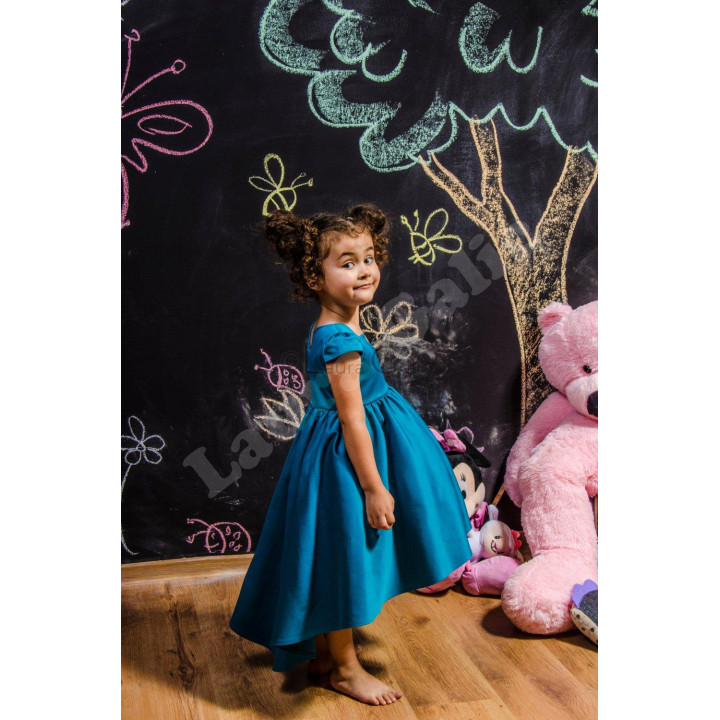 Side view of the turquoise Mini Alegra Dress showing its defined waist and full skirt