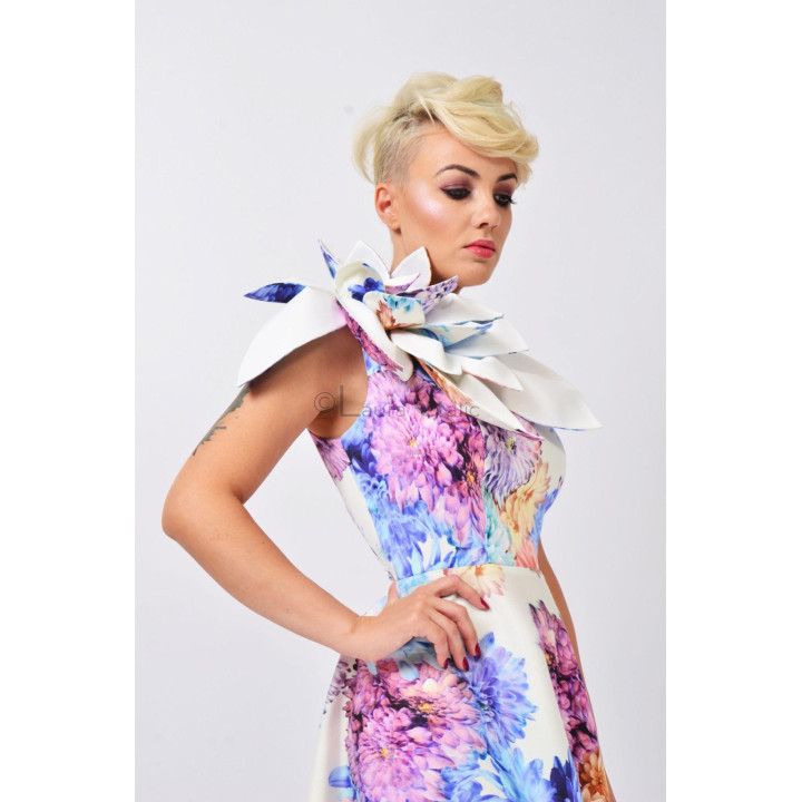 Close-up of the asymmetric neckline and layered flower appliqué on the Izaura 5 dress