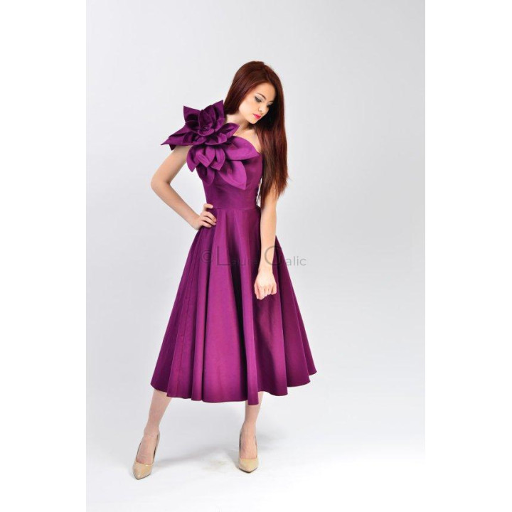 Izaura 6 dress showing its asymmetric neckline and layered shoulder flower