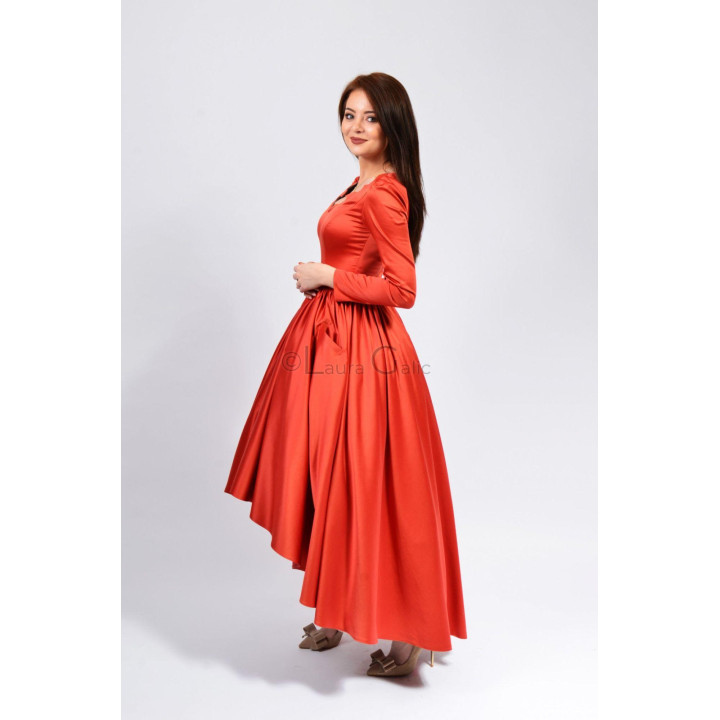 Side view of the Alegra dress showing its fitted bodice and full red-coral skirt