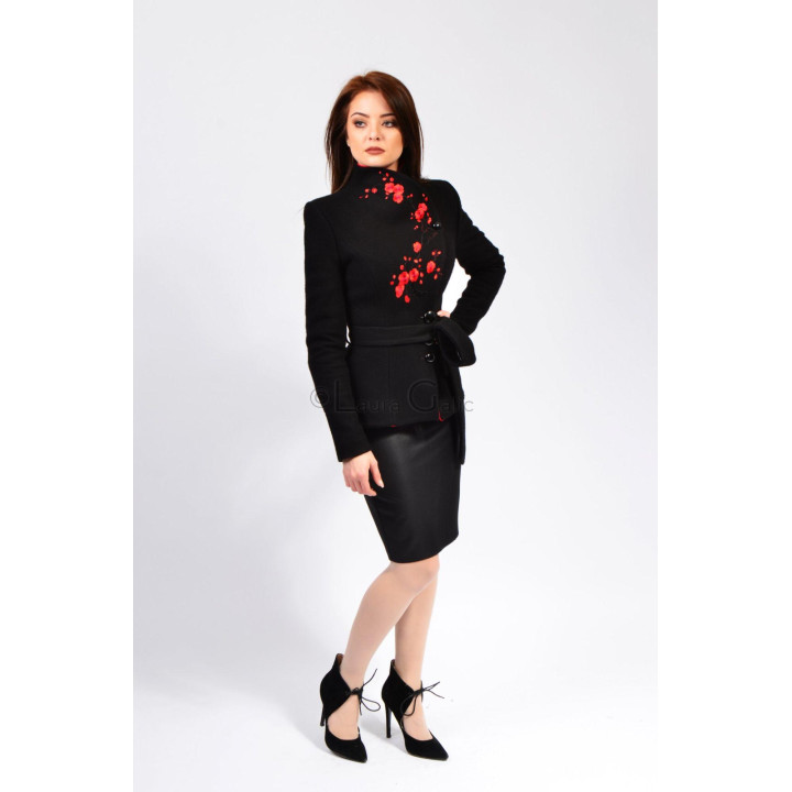 Full-length view of the black Luca short coat with red floral detail and a waist belt