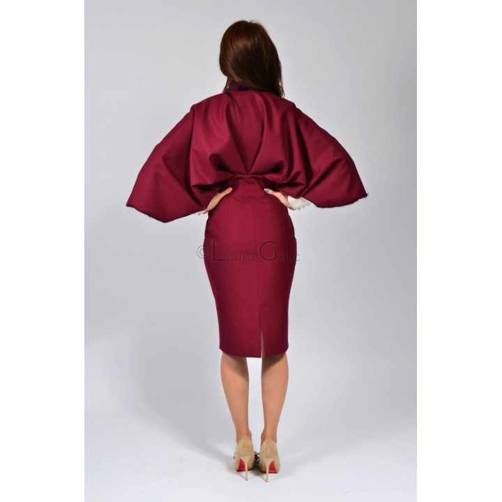 Back view of the Doina coat with cape-style sleeves and a slit at the hem