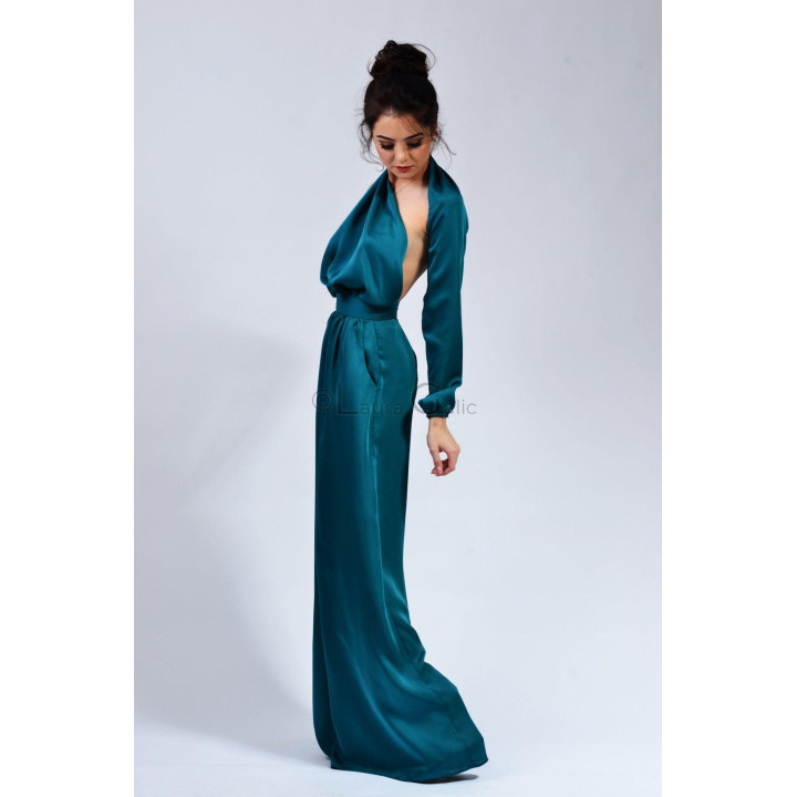 Side view of the Brandusa jumpsuit showing its one-sleeve design and draped neckline