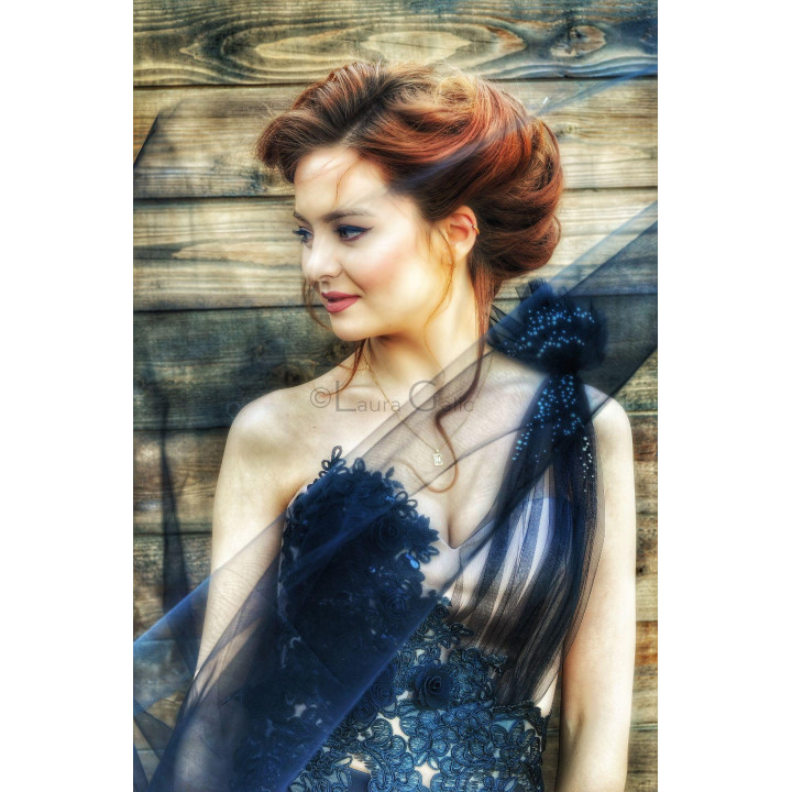 Evolette corset with floral lace and sheer tulle draped over the shoulder