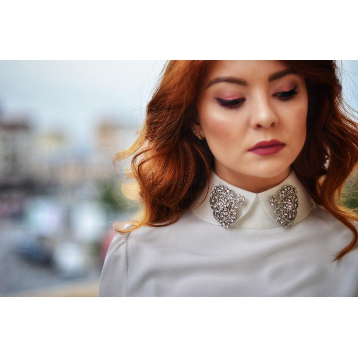 Close-up of the Aniela shirt’s high collar with sparkling decorative appliqués