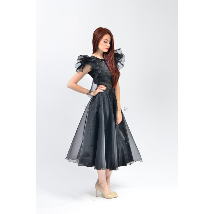 Side view of the Aliona dress showing its defined waist and flared skirt