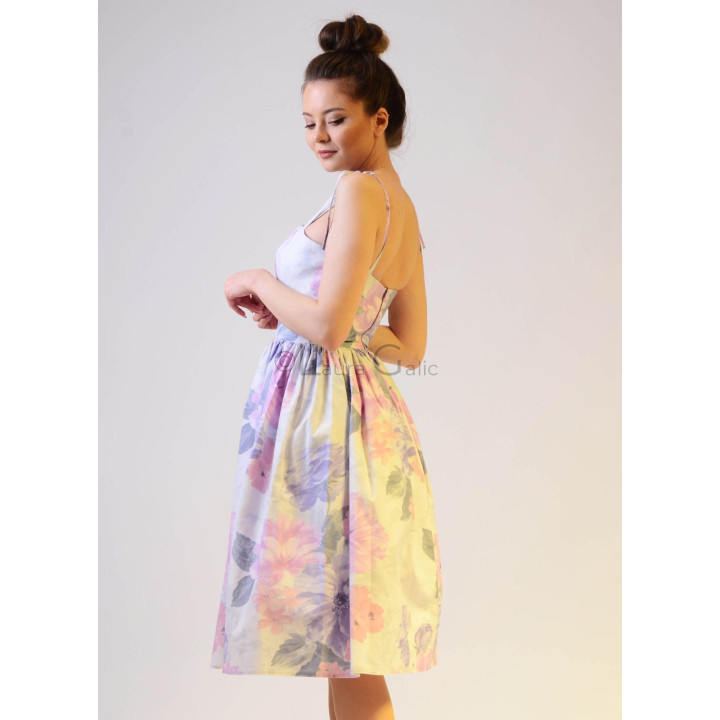 Side view of the Dalma floral dress with slim straps and a full skirt