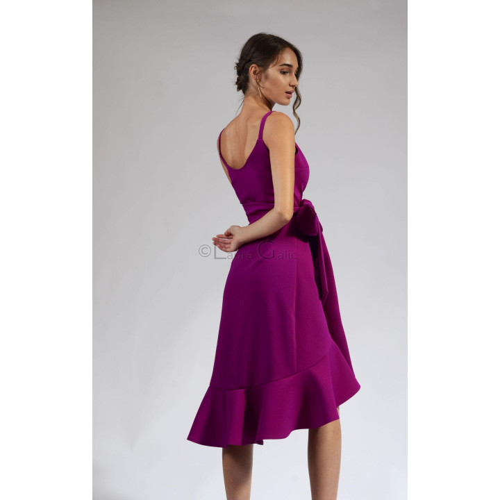 Back view of the Chiara dress with a low neckline and a wide ruffled hem