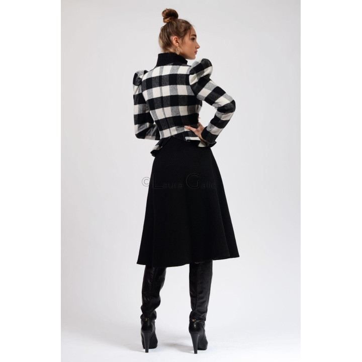 Back view of the Enia 2 coat with a checked upper section and full black skirt