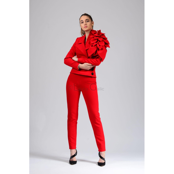 Delia suit showing the oversized flower on the jacket shoulder and matching trousers