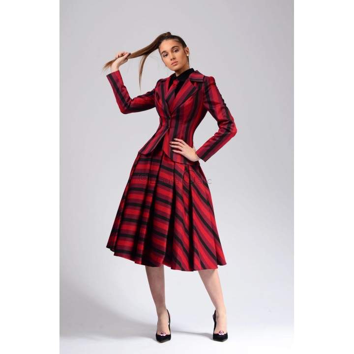 Ava 3 suit worn with the blazer buttoned, showing its lapels and coordinated striped skirt