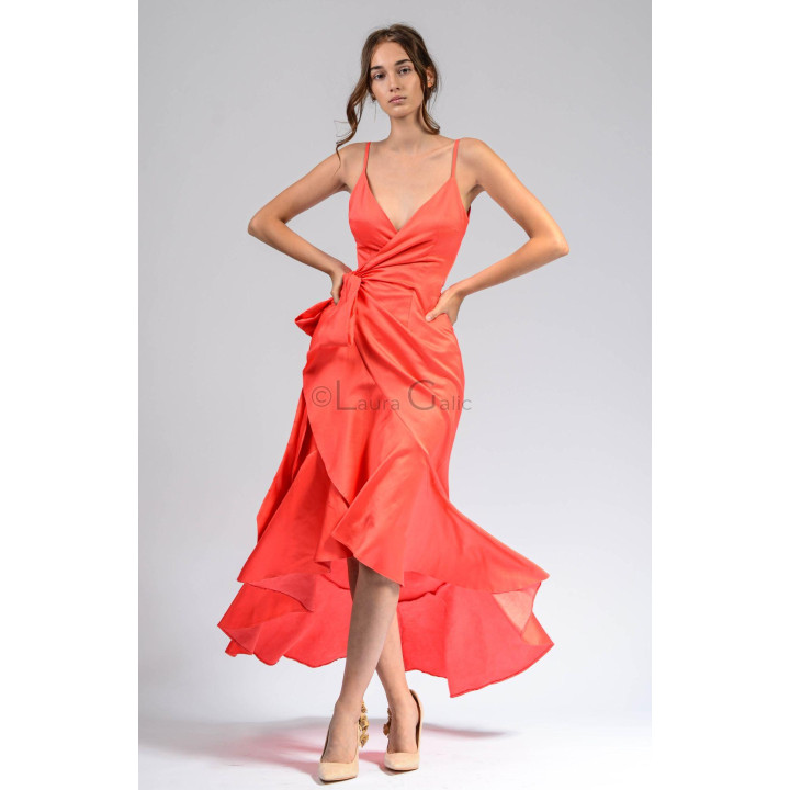 Front view of the Chiara 4 coral dress with a side waist tie and flowing ruffled skirt