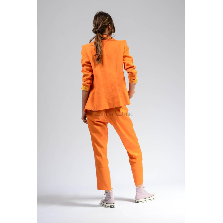 Back view of the orange Ramona suit with its long blazer and trousers