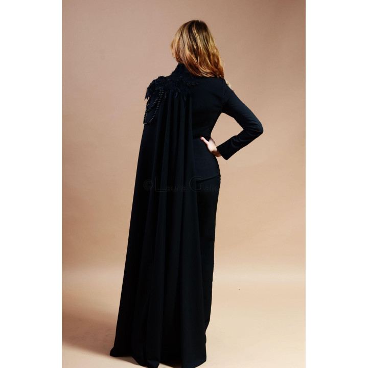 Back view of the Euridice suit showing the long cape and shoulder appliqués