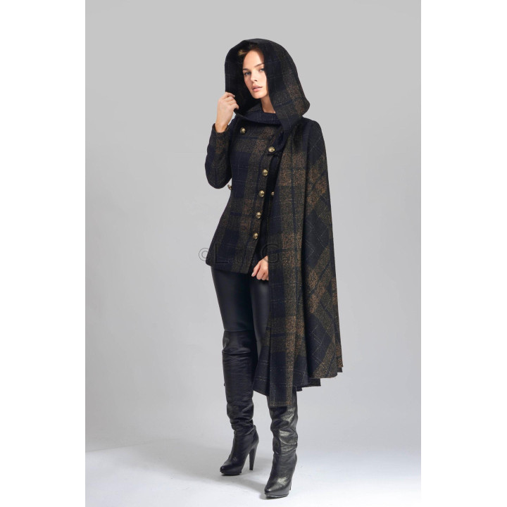 Rebecca 1 coat worn with the hood up and detachable cape draped over one shoulder