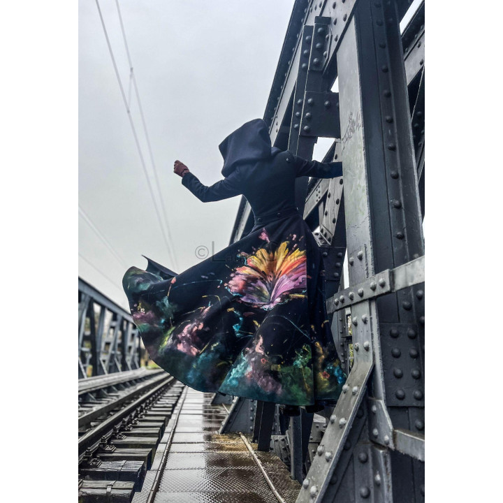 Rebecca coat with its painted train lifted to show the flowing volume