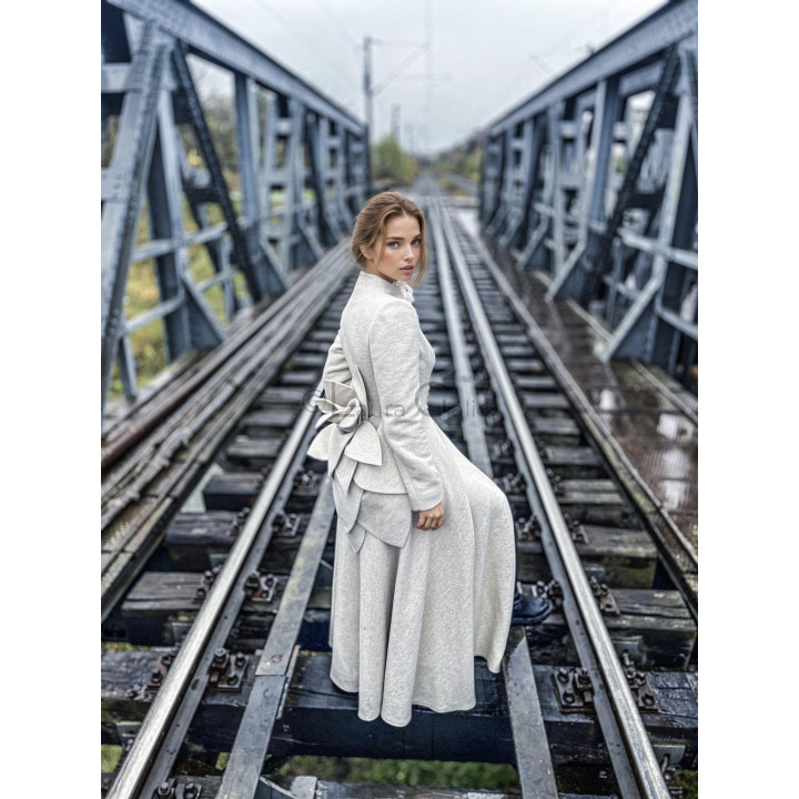 Side view of the Tamura Amaryllis coat with a fitted waist and full skirt
