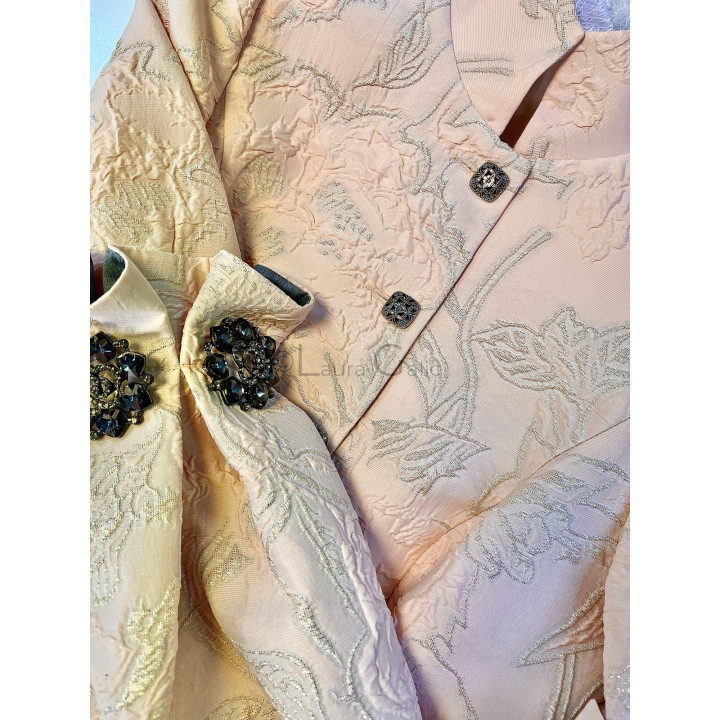 Close detail of the jacket's raised floral pattern and gold-thread brocade