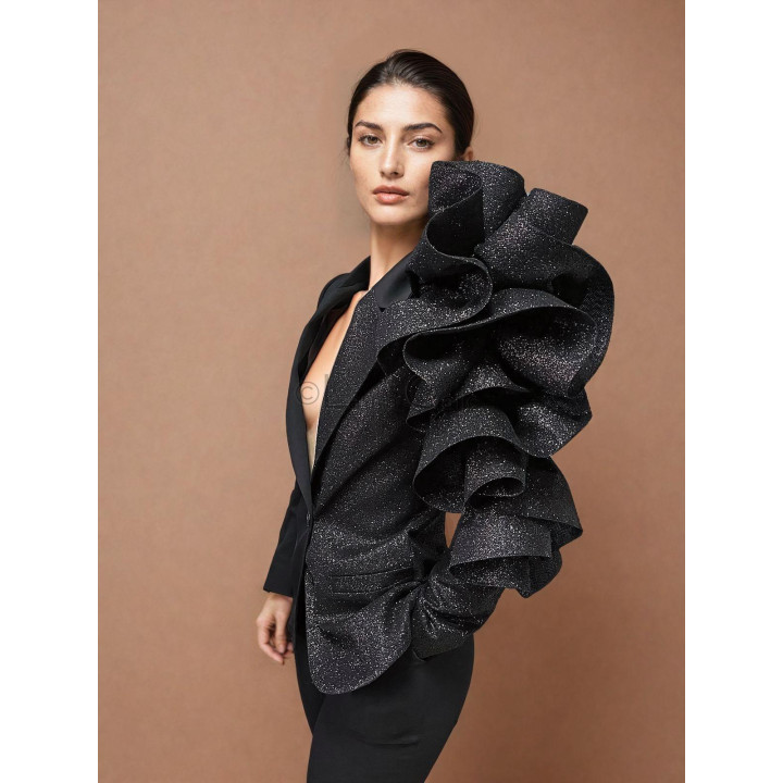 Close-up of the Daria jacket's classic lapel and sparkling tulle ruffle across the shoulder and sleeve
