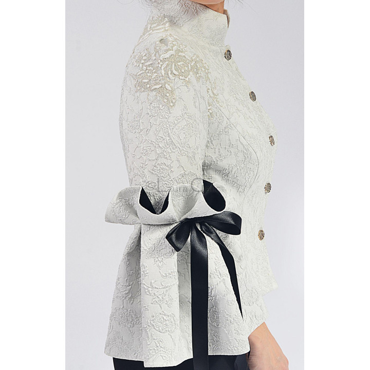 Close detail of the Federica 2 jacket’s decorative buttons, floral brocade and black sleeve bow