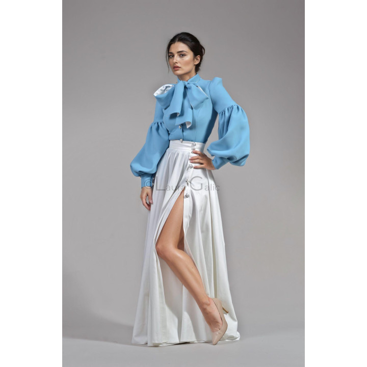 Detail of the Luana suit showing its oversized jacket bow and voluminous sleeves with the Cezara skirt