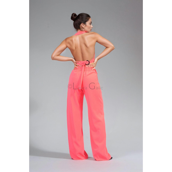 Open back of the Charlie vest with a waist strap and circular detail, paired with wide-leg trousers