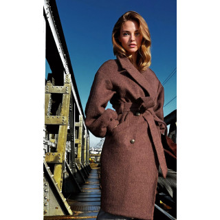 Close detail of the Laura coat’s wide lapels, voluminous sleeves and waist belt
