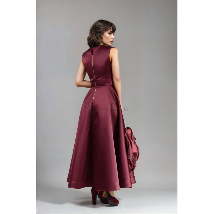 Back view of the Lara dress showing its zipper and full burgundy skirt