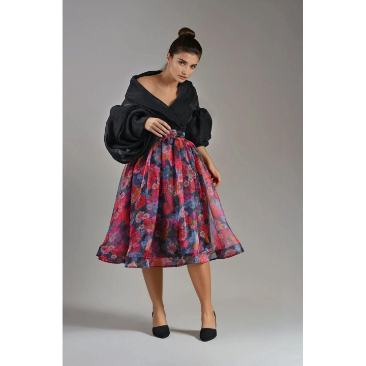Close view of the pleated waistband and floral organza on the Denisa midi skirt