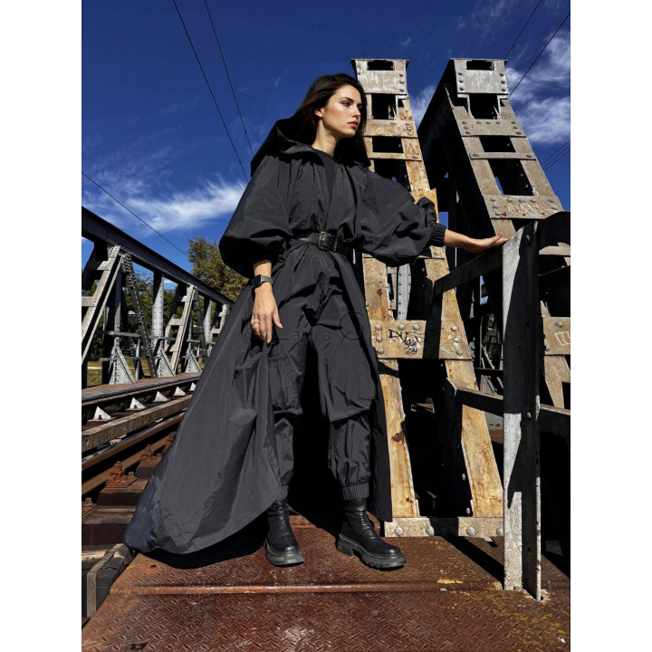 Black hooded cape with voluminous sleeves and matching cargo trousers
