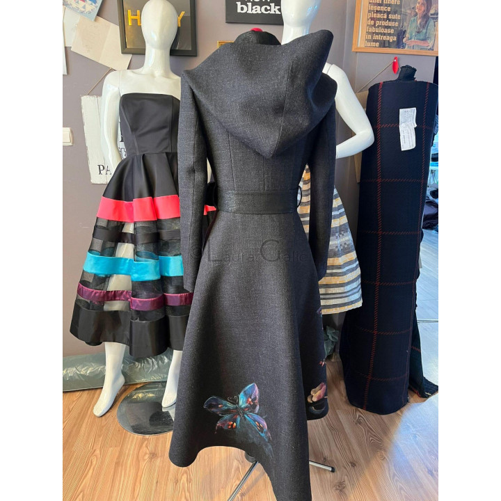 Back of the Lavinia coat, showing the defined waist and butterfly motif near the hem