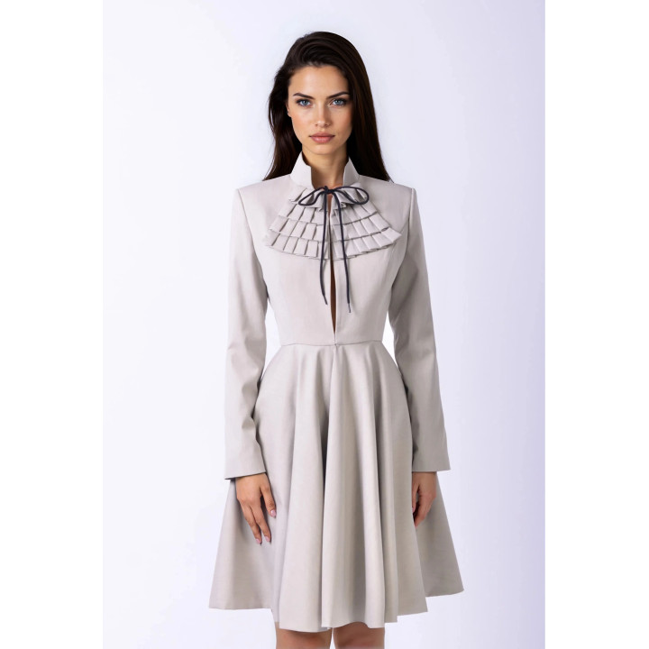 Close-up of the Aurora coat’s high collar, layered chest pleats and dark tie bow