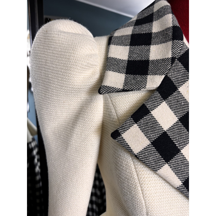 Close-up of the cream jacket texture beside its black-and-white checked lapel