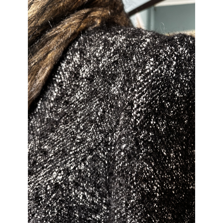 Close-up of the black-and-white flecked wool fabric on the Gaia 2 coat