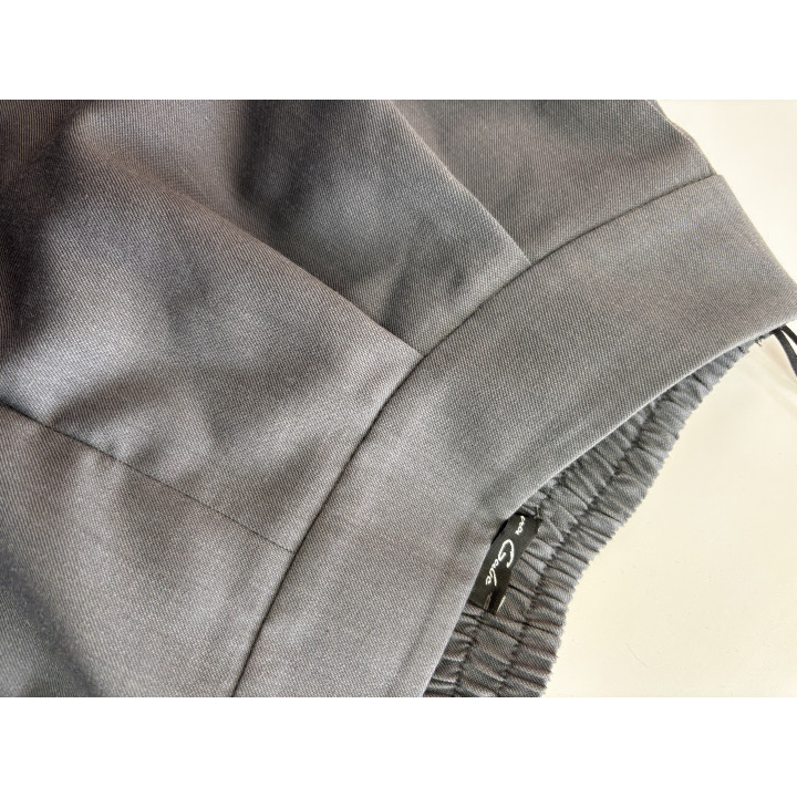 Close-up of the Charlie trousers’ waistband and finely textured grey fabric