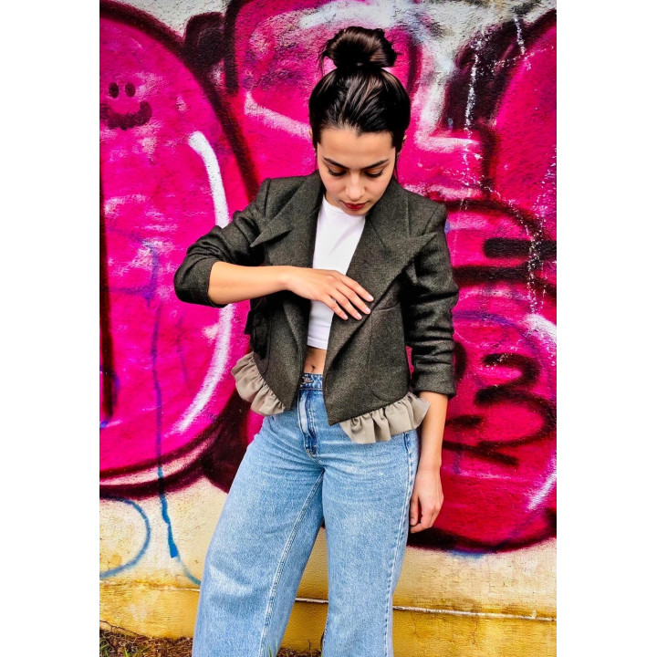 Torry oversized wool jacket with wide lapels and beige ruffled hem, styled with jeans